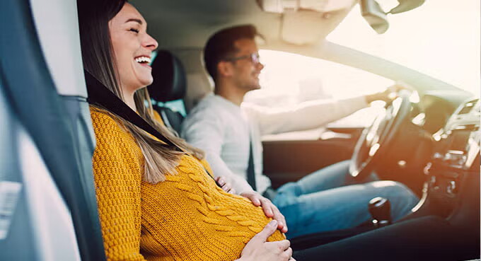 Pregnant woman and her husband on trip.