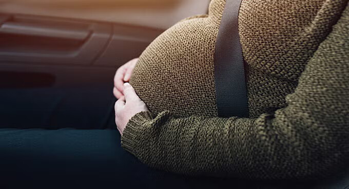 Pregnant woman in car