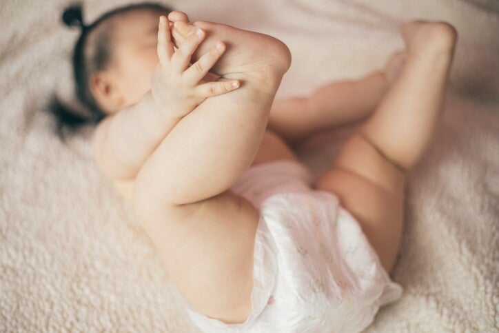 ทารกนอนเล่นบนพรม